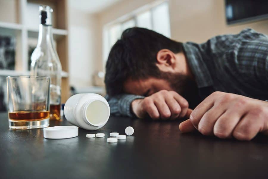 A man feeling sick after drinking alcohol while being on Lexapro.