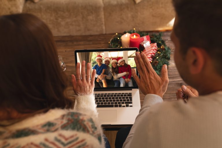 Two people participating in a video call with their loved ones during the holidays.