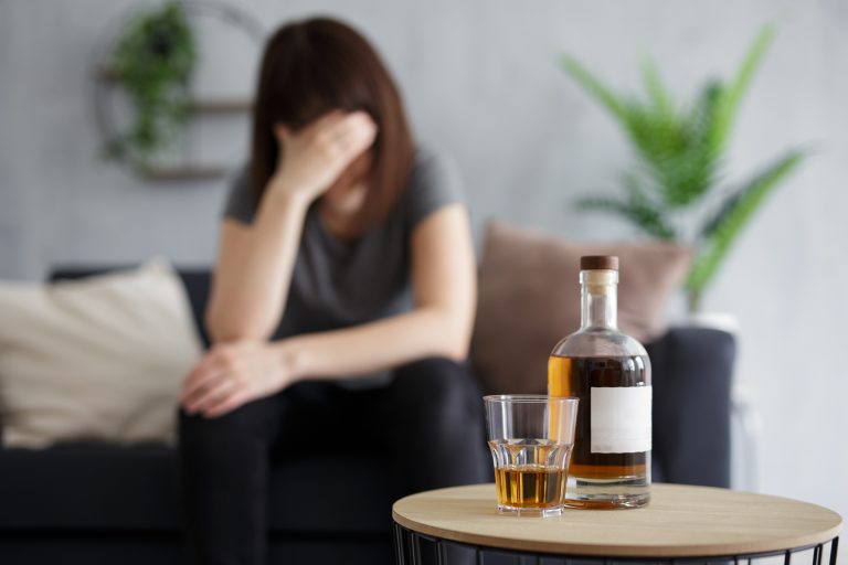 A woman struggling with alcohol dependence at home.