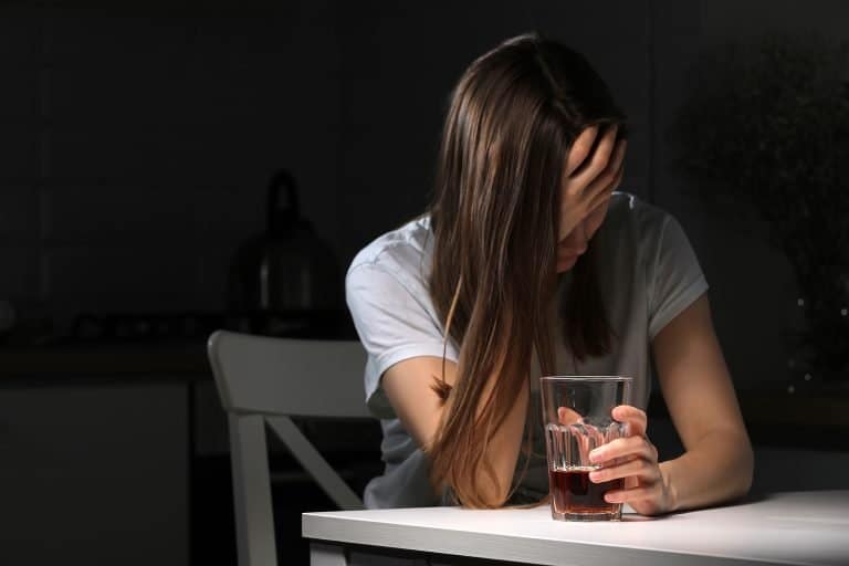 A woman struggling with alcohol addiction.
